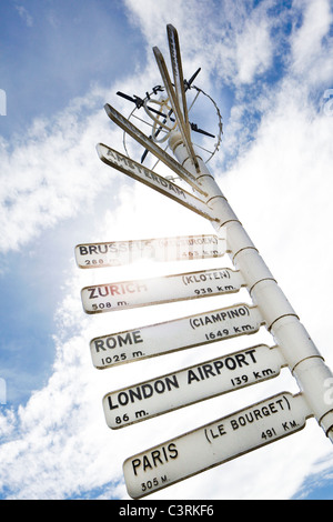 Finger post at Birmingham Airport, highlighting distance to international destinations. Stock Photo
