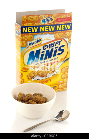 500 gram box of New Weetabix honey crispy minis breakfast cereal bowl milk and spoon Stock Photo