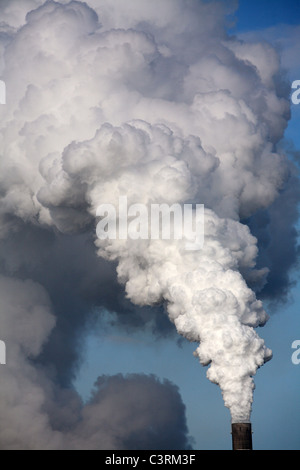 Exhaust in the form of white smoke coming out of a chimney Stock Photo