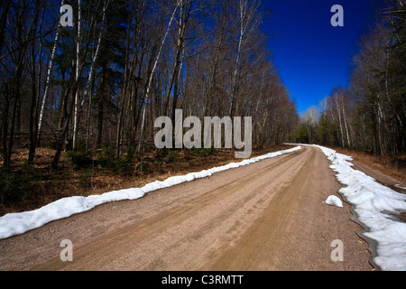 Dirt road with snow on side Stock Photo