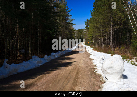 Dirt road with snow on side Stock Photo