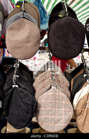Flat caps on sale at a market stall Stock Photo
