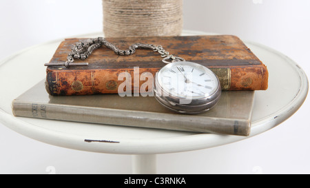 Old fob watch on old book Stock Photo