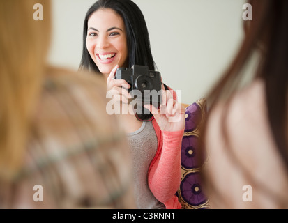 Woman taking photograph of friends Stock Photo