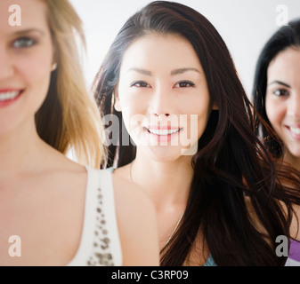 Smiling friends standing together Stock Photo