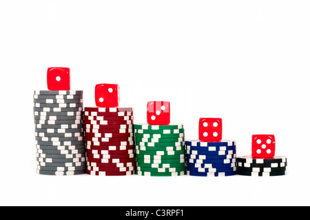 Poker Chips piled and red dice in row over it isolated on white background Stock Photo