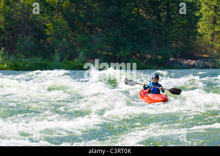 Caucasian girl kayaking in river Stock Photo