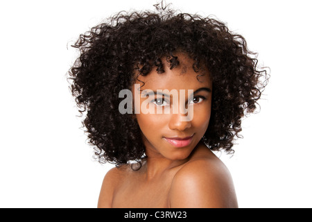 Beautiful happy female face with smooth skin and dark curly hair, isolated. Stock Photo