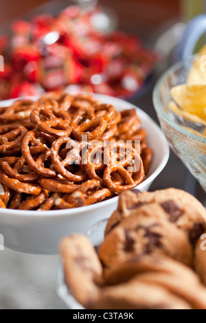 Closeup of delicious cookies and pretzels in bowls, with shallow DOF Stock Photo