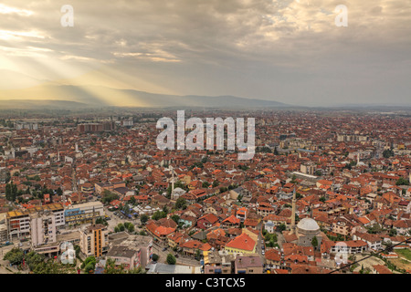 city scape of second biggest city Prizren in Kosovo at sunset with red roofed houses and mosques and river. Stock Photo