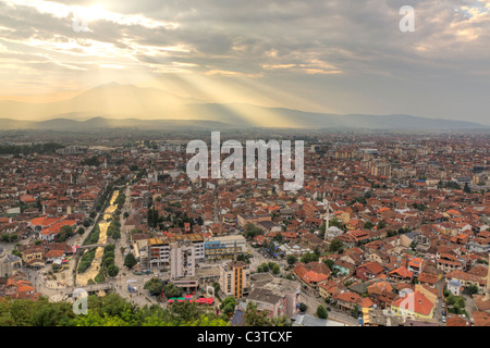 city scape of second biggest city Prizren in Kosovo at sunset with red roofed houses and mosques and river. Stock Photo