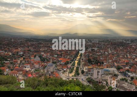 city scape of second biggest city Prizren in Kosovo at sunset with red roofed houses and mosques and river. Stock Photo