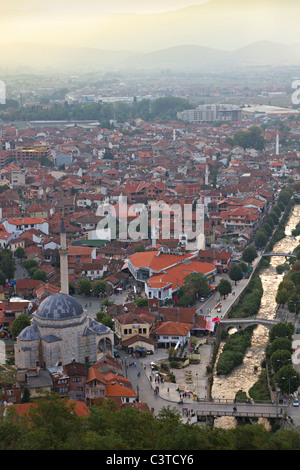 city Prizren in Kosovo at sunset with red roofed houses and mosques and river. Stock Photo