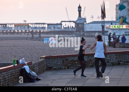 Couple dancing on the seafront, Brighton, Sussex Stock Photo