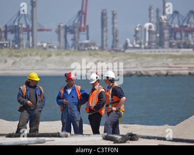 Men discussing their work in the port of Rotterdam, building the new Maasvlakte 2 area. the Netherlands Stock Photo