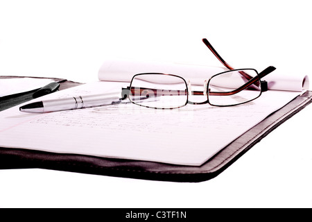 sunglasses and pen place on note book isolate on white background Stock Photo