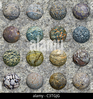 A set of stone balls against a granite wall - seamless texture Stock Photo
