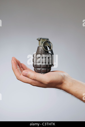Man holding a hand grenade in his hand Stock Photo