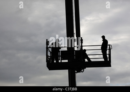 Technicians on a work platform Stock Photo