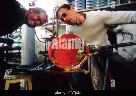 Robert Pierini and his son are both glass blower master. They are modeling artistic pieces into their workshop of Biot Stock Photo