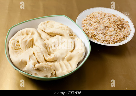 Bread or cookie dough near roasted grind nuts on a table Stock Photo
