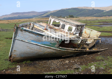 Shipwrecked boat on the shoreline left to rot in Isle of Mull Inner Hebrides Scotland Stock Photo