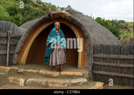 Sotho woman in front of hut, Basotho Cultural Village, Golden Gate Highlands National Park, South Africa Stock Photo