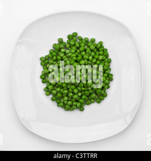 a bunch of peas on a white plate Stock Photo