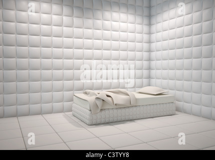 white mental hospital padded room corner with a bed Stock Photo