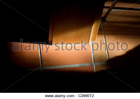 Close-up of terracotta floor tiles with turquoise insert Stock Photo