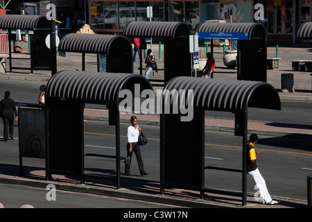 Commuters walk through an empty bus station in Ghandi Square, CBD, Johannesburg. South Africa. Stock Photo