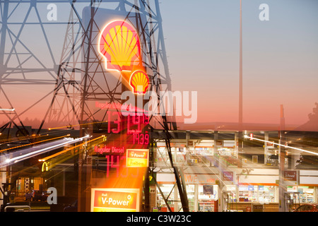 A petrol sation in Billingham on Teeside, UK, with an electricity pylon at dusk. Stock Photo