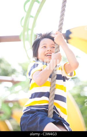 Boy Swining on Rope Stock Photo