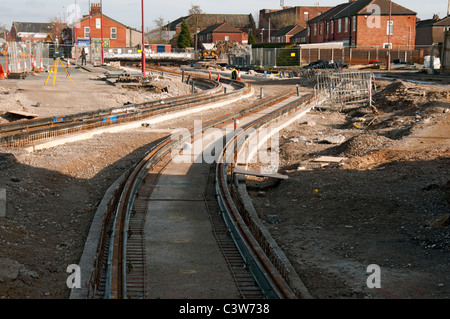 Metrolink on-street light rail (tram) system under construction at Manchester Road, Droylsden, Manchester, England, UK Stock Photo