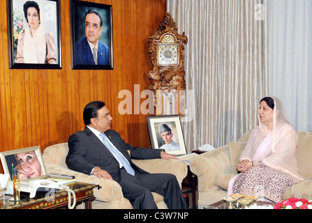 President, Asif Ali Zardari exchanges views with Federal Minister for Environment Samina Khalid Ghurki during meeting - Stock Photo