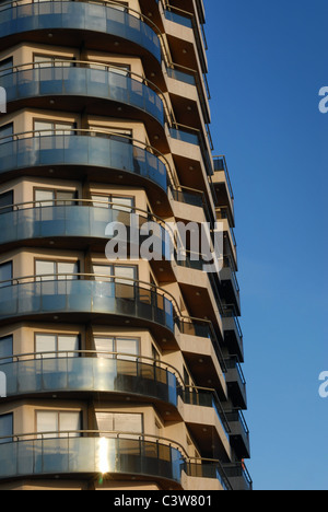 Modern building with balcony on a blue sky background  Stock Photo