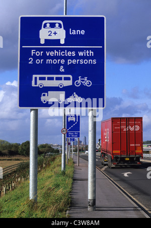 lorry passing warning roadsign of high occupancy lane ahead for vehicles carrying two or more people to ease congestion Leeds UK Stock Photo