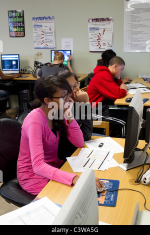 Students collaborate on class project using computer in classroom at Rapoort Academy public charter high school in Waco Texas Stock Photo