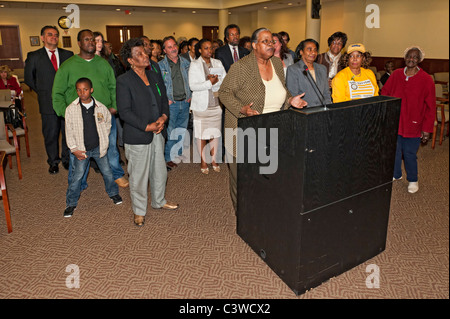 Protesters behind podium at Nassau County Legislative Redistricting public hearing, May 9, 2011, Mineola, NY Stock Photo