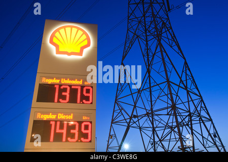 A petrol station in Billingham on Teeside, UK, with an electricity pylon at dusk. Stock Photo