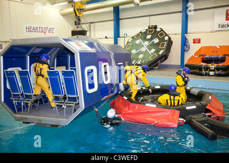 Workers in the offshore industry practice helicopter ditching evacuation as part of an industry training course Stock Photo