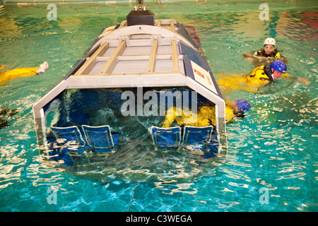 Workers in the offshore industry practice helicopter ditching evacuation as part of an industry training course Stock Photo
