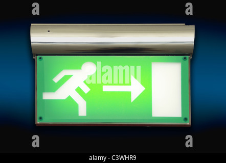 Emergency blinking exit sign over blue background Stock Photo