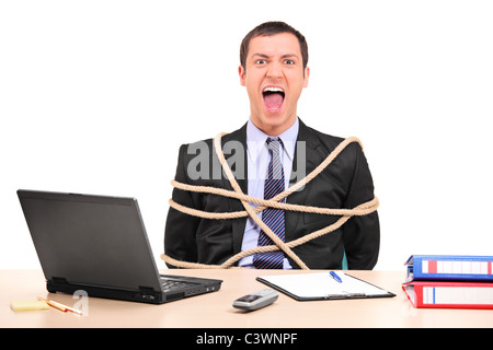 A businessman tied up with rope in the office Stock Photo