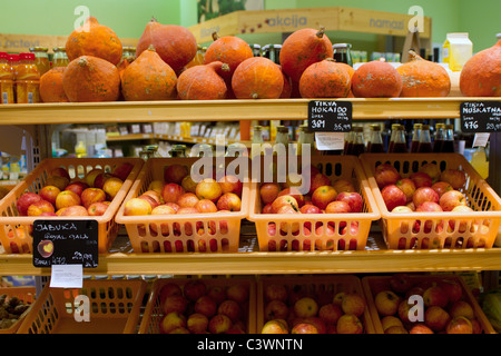 Apples and pumpkins on the shelves in store with organic food Stock Photo
