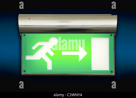 Emergency blinking exit sign over blue background Stock Photo