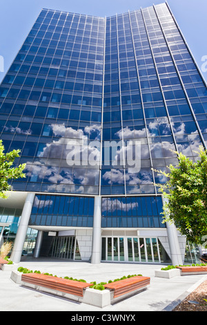 Modern Corporate Building with sky and clouds reflecting Stock Photo