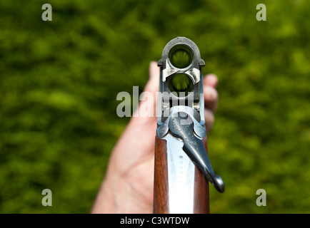 open under and over double barrel shotgun looking down through the barrels.landscape format.copy space. Stock Photo