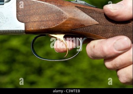 close up of mans finger on the trigger of a double barrel shotgun.landscape format.copy space. Stock Photo