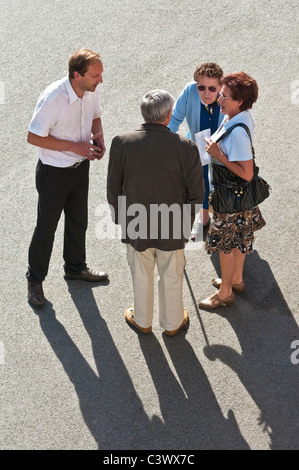 Overhead view of four people talking in street - France. Stock Photo
